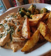 smoked paprika chicken alfredo with feta tahini cream crispy brussels potato combo wedges